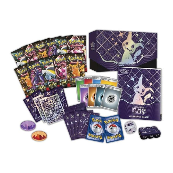Caja de Entrenador Élite Pokémon Destinos de Paldea con sobres, guía, fundas, dados y accesorios en tonos morados y negros.